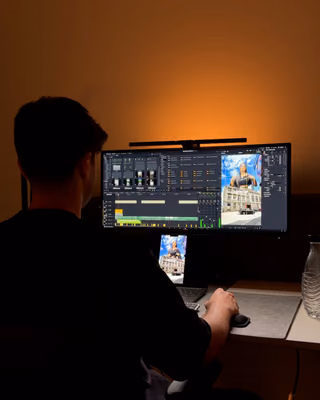 Max am Schreibtisch im orangen Licht beim Videoschnitt